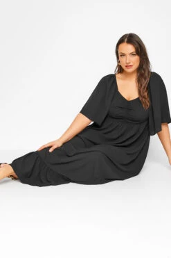 LIMITED COLLECTION Curve Black Ruched Angel Sleeve Dress 8 LIMITED COLLECTION Curve Black Ruched Angel Sleeve Dress -Saga Dresses Shop 67b5a4e6 96f1 44 214535 D